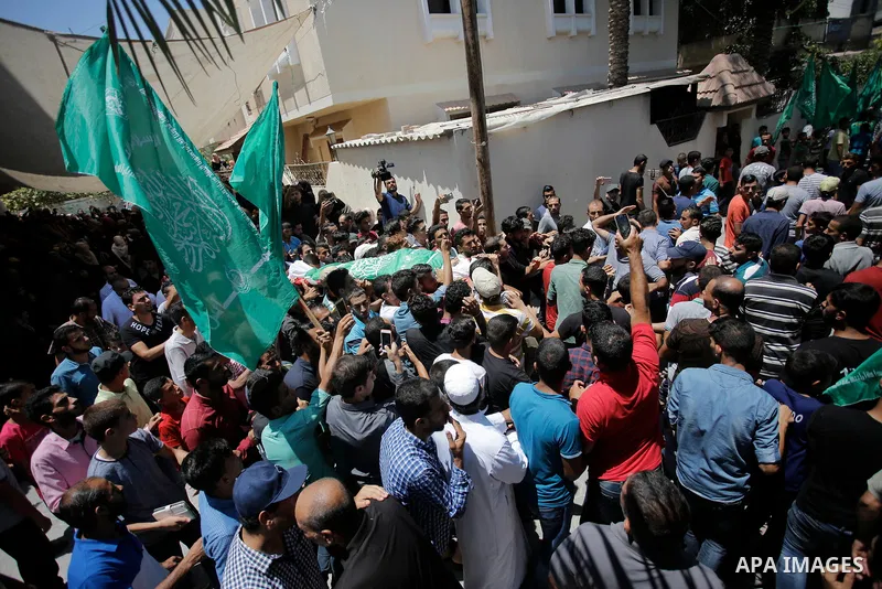 Palestinian mourners carry the body of Ezzedine al-Qassam miltant, Mohammed Abu Daqqa, who was killed in an Israeli strike, during his funeral in Khan Younis in the southern of Gaza Strip, on 21 Jul 2018. Israel air stri...