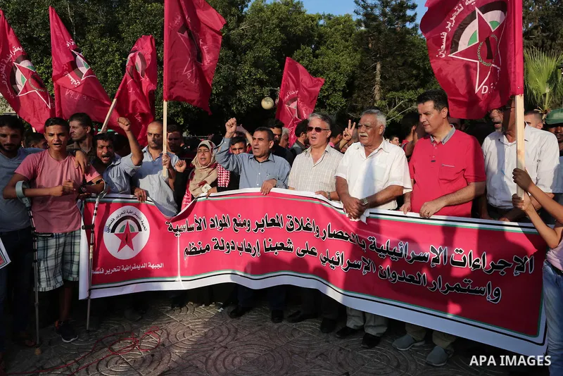 Palestinian Supporters of the Democratic Front for the Liberation of Palestine take part in a protest demanding to lift the sanctions on Gaza Strip and against the continued Israeli siege, in Gaza city on July 22, 2018....