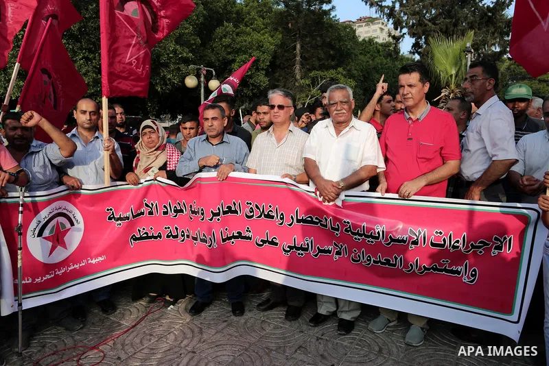 Palestinian Supporters of the Democratic Front for the Liberation of Palestine take part in a protest demanding to lift the sanctions on Gaza Strip and against the continued Israeli siege, in Gaza city on July 22, 2018....