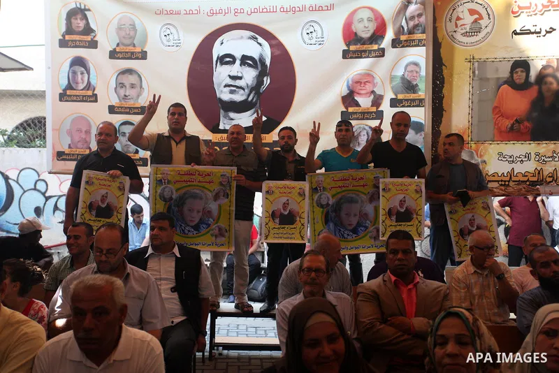 Palestinians take part in a protest to show solidarity with Palestinian prisoners held in Israeli jails, in front of Red cross office in Gaza city on July 23, 2018. Photo by Mahmoud Ajour