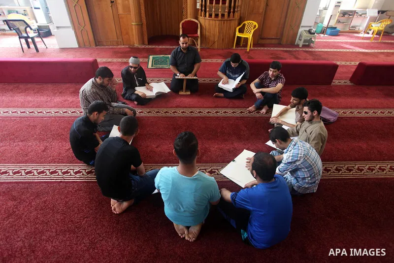Palestinian blind boys read and memorise the holy Quran in braille at Dar al-Quran and Sunnah in Gaza city, on July 23, 2018. Photo by Mahmoud Ajour