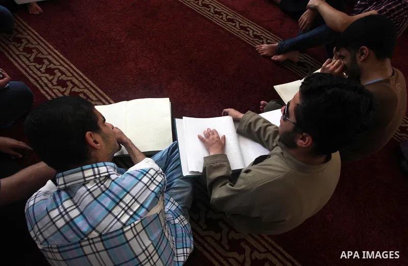 Palestinian blind boys read and memorise the holy Quran in braille at Dar al-Quran and Sunnah in Gaza city, on July 23, 2018. Photo by Mahmoud Ajour