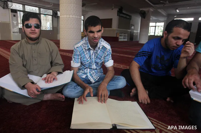 Palestinian blind boys read and memorise the holy Quran in braille at Dar al-Quran and Sunnah in Gaza city, on July 23, 2018. Photo by Mahmoud Ajour