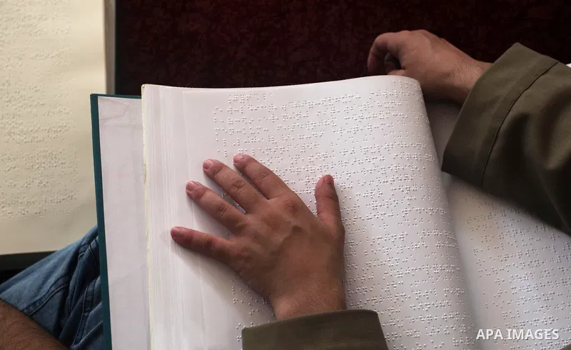 A Palestinian blind boy reads and memorise the holy Quran in braille at Dar al-Quran and Sunnah in Gaza city, on July 23, 2018. Photo by Mahmoud Ajour