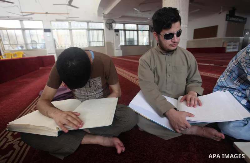 Palestinian blind boys read and memorise the holy Quran in braille at Dar al-Quran and Sunnah in Gaza city, on July 23, 2018. Photo by Mahmoud Ajour