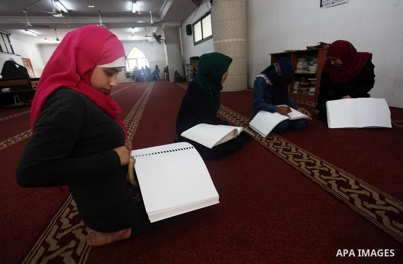 Palestinian blind girls read and memorise the holy Quran in braille at Dar al-Quran and Sunnah in Gaza city, on July 23, 2018. Photo by Mahmoud Ajour