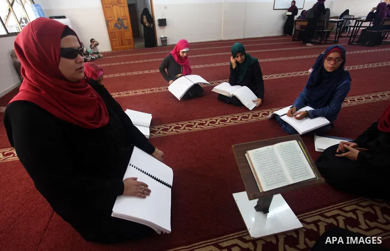 Palestinian blind girls read and memorise the holy Quran in braille at Dar al-Quran and Sunnah in Gaza city, on July 23, 2018. Photo by Mahmoud Ajour