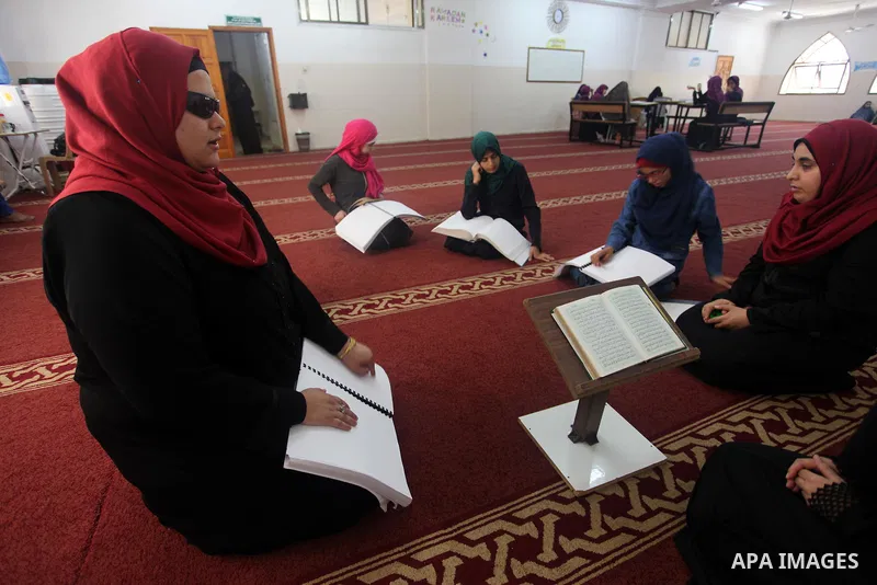 Palestinian blind girls read and memorise the holy Quran in braille at Dar al-Quran and Sunnah in Gaza city, on July 23, 2018. Photo by Mahmoud Ajour