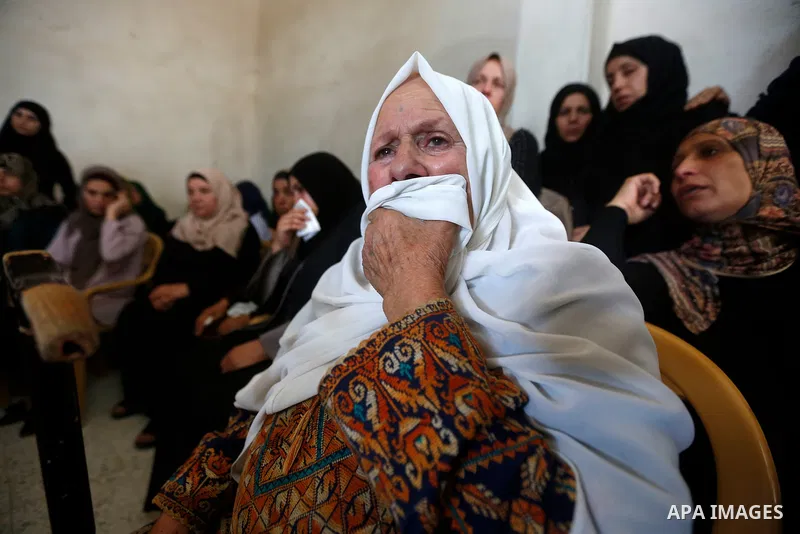 Relatives of Palestinian teenager Arkan Mezeher, who was killed by Israeli soldiers during a raid, mourn during his funeral in Dheishe refugee camp, near West Bank city of Bethlehem on July 23, 2018. Photo by Wisam Hashl...