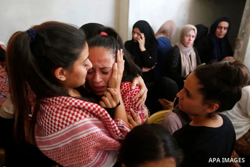Relatives of Palestinian teenager Arkan Mezeher, who was killed by Israeli soldiers during a raid, mourn during his funeral in Dheishe refugee camp, near West Bank city of Bethlehem on July 23, 2018. Photo by Wisam Hashl...