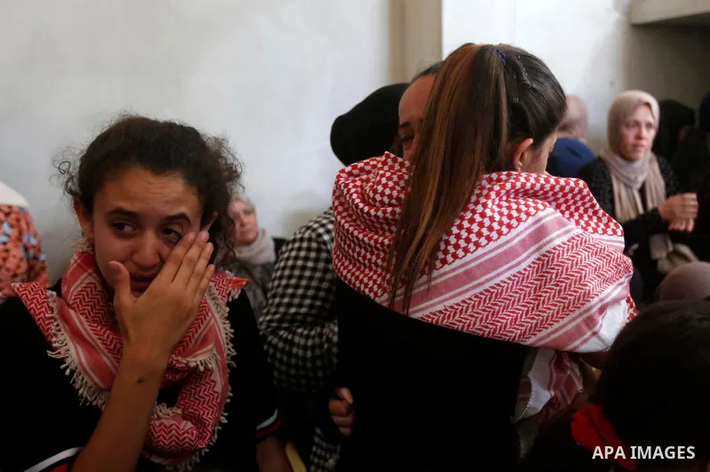 Relatives of Palestinian teenager Arkan Mezeher, who was killed by Israeli soldiers during a raid, mourn during his funeral in Dheishe refugee camp, near West Bank city of Bethlehem on July 23, 2018. Photo by Wisam Hashl...