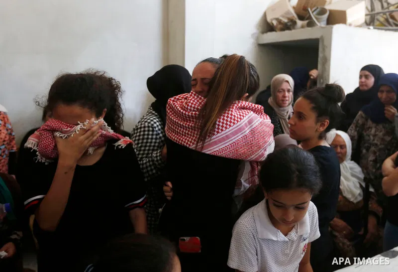 Relatives of Palestinian teenager Arkan Mezeher, who was killed by Israeli soldiers during a raid, mourn during his funeral in Dheishe refugee camp, near West Bank city of Bethlehem on July 23, 2018. Photo by Wisam Hashl...