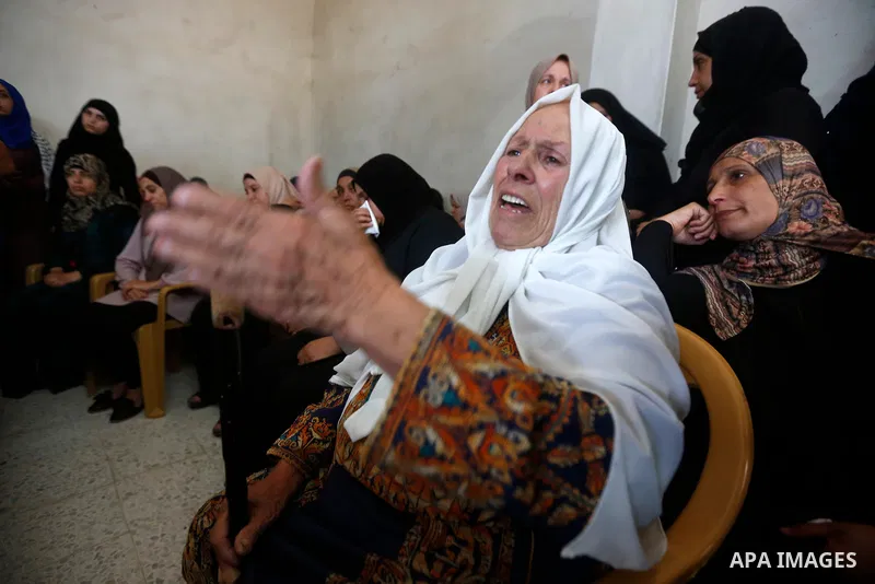 Relatives of Palestinian teenager Arkan Mezeher, who was killed by Israeli soldiers during a raid, mourn during his funeral in Dheishe refugee camp, near West Bank city of Bethlehem on July 23, 2018. Photo by Wisam Hashl...