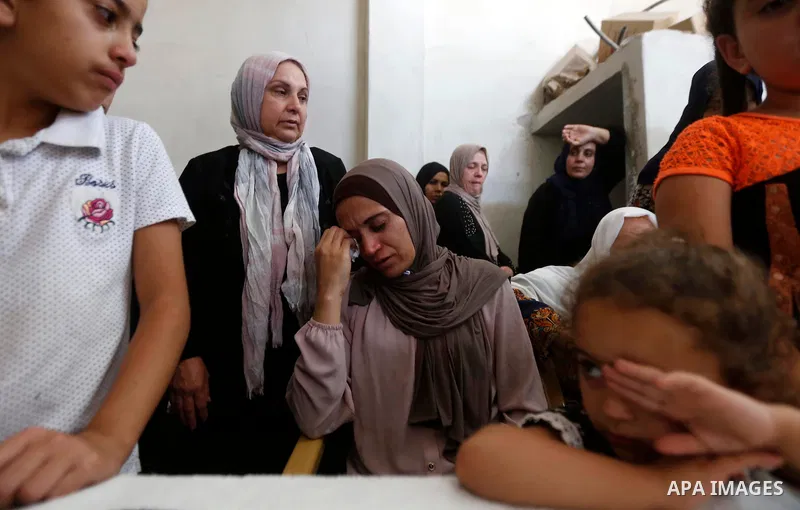 Relatives of Palestinian teenager Arkan Mezeher, who was killed by Israeli soldiers during a raid, mourn during his funeral in Dheishe refugee camp, near West Bank city of Bethlehem on July 23, 2018. Photo by Wisam Hashl...