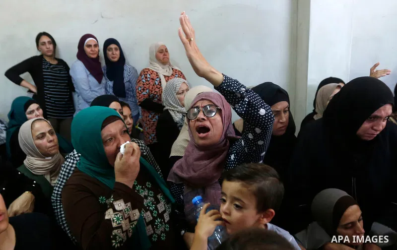 Relatives of Palestinian teenager Arkan Mezeher, who was killed by Israeli soldiers during a raid, mourn during his funeral in Dheishe refugee camp, near West Bank city of Bethlehem on July 23, 2018. Photo by Wisam Hashl...