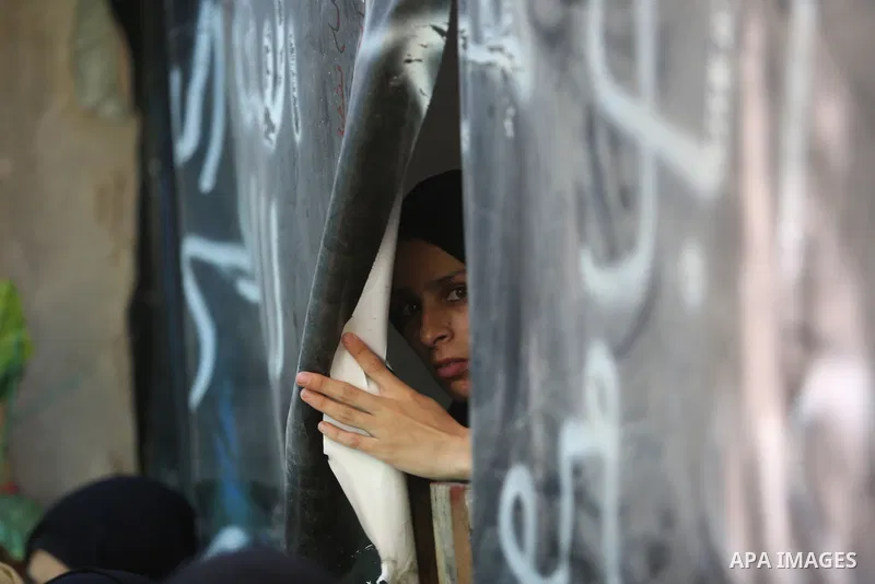 Mourners carry the body of Palestinian Karam Arafat, who died of wounds he sustained during clashes with Israeli troops, during his funeral in Khan Younis in the southern of Gaza strip on July 23, 2018. Photo by Ashraf A...