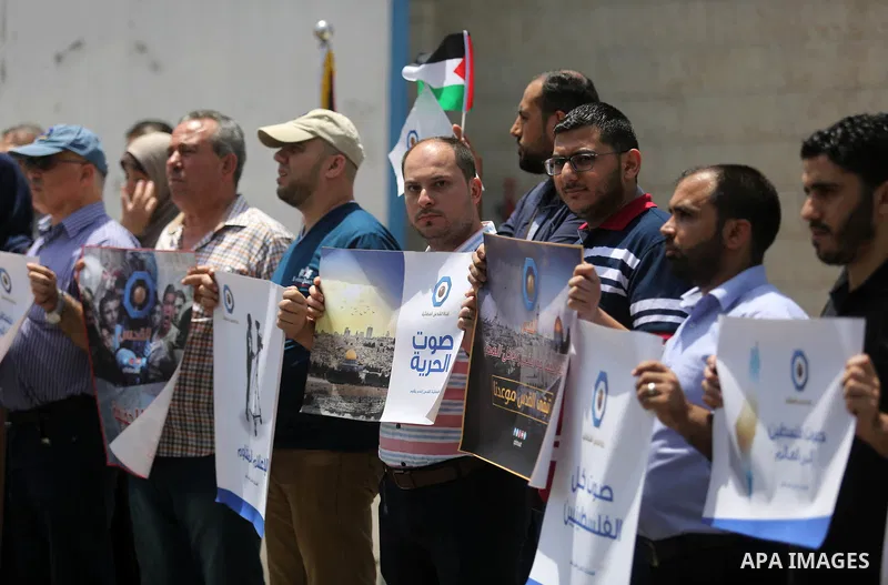Palestinian journalists take part in a protest against the decision of the Israeli occupation to block work in Al-Quds TV in Jerusalem and West Bank, in front of the High Commissioner for Human Rights, in Gaza city on Ju...