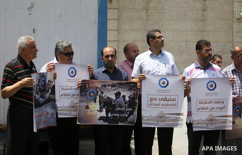 Palestinian journalists take part in a protest against the decision of the Israeli occupation to block work in Al-Quds TV in Jerusalem and West Bank, in front of the High Commissioner for Human Rights, in Gaza city on Ju...