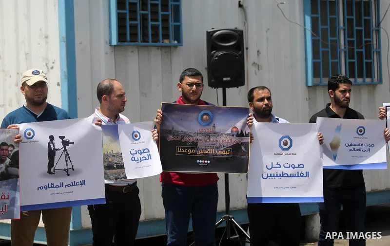 Palestinian journalists take part in a protest against the decision of the Israeli occupation to block work in Al-Quds TV in Jerusalem and West Bank, in front of the High Commissioner for Human Rights, in Gaza city on Ju...