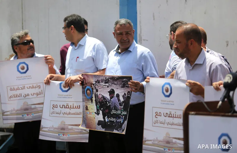 Palestinian journalists take part in a protest against the decision of the Israeli occupation to block work in Al-Quds TV in Jerusalem and West Bank, in front of the High Commissioner for Human Rights, in Gaza city on Ju...
