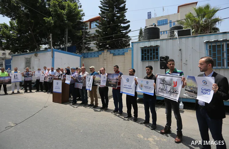 Palestinian journalists take part in a protest against the decision of the Israeli occupation to block work in Al-Quds TV in Jerusalem and West Bank, in front of the High Commissioner for Human Rights, in Gaza city on Ju...