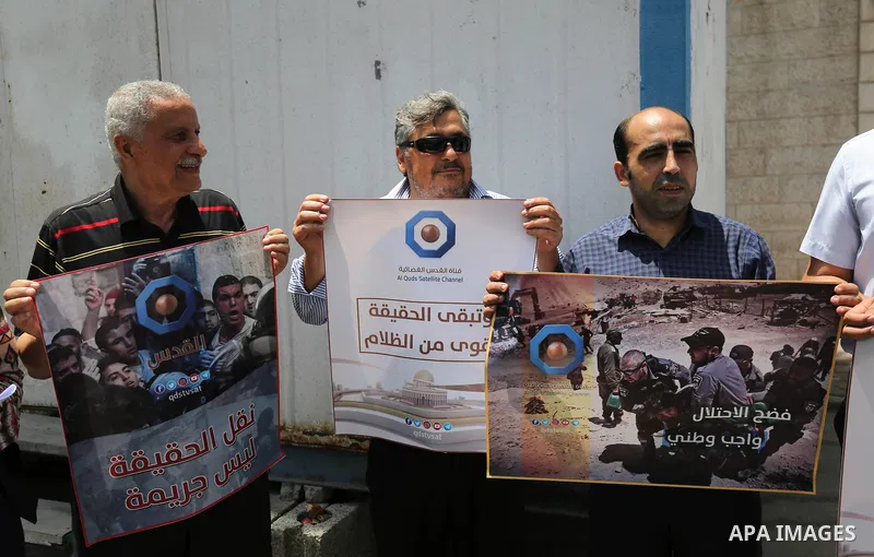 Palestinian journalists take part in a protest against the decision of the Israeli occupation to block work in Al-Quds TV in Jerusalem and West Bank, in front of the High Commissioner for Human Rights, in Gaza city on Ju...