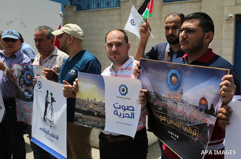 Palestinian journalists take part in a protest against the decision of the Israeli occupation to block work in Al-Quds TV in Jerusalem and West Bank, in front of the High Commissioner for Human Rights, in Gaza city on Ju...