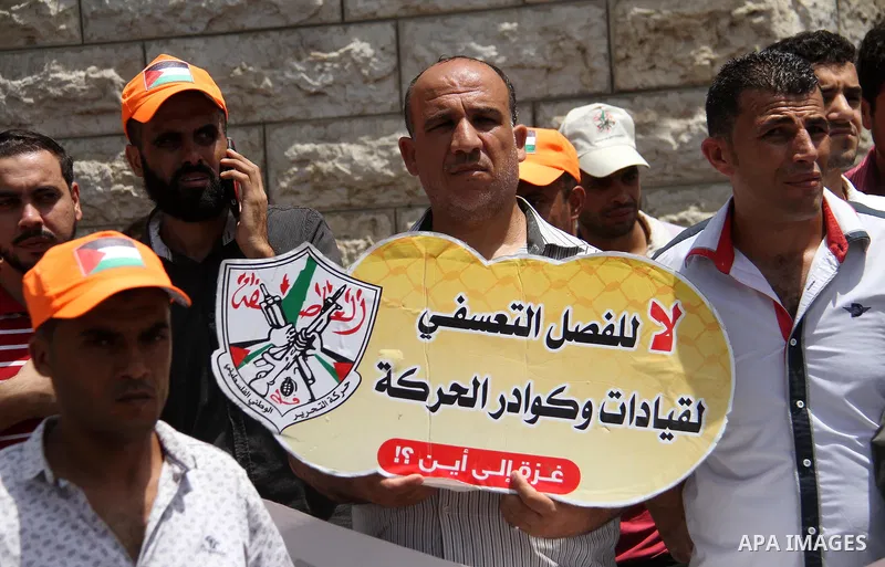 Palestinian Authority employees in the Gaza Strip take part in a protest demanding their salaries in front of the headquarters of the Council of Ministers, in Gaza city on July 24, 2018. Photo by Mahmoud Ajour