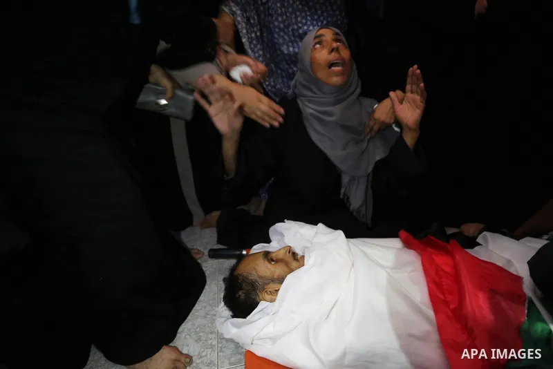 Relatives of Palestinian Majdi Oqeel, who died of wounds he sustained during clashes with Israeli troops, mourn over his body during his funeral, in Jabalia in the northern of Gaza Strip on July 24, 2018. Photo by Ashraf...