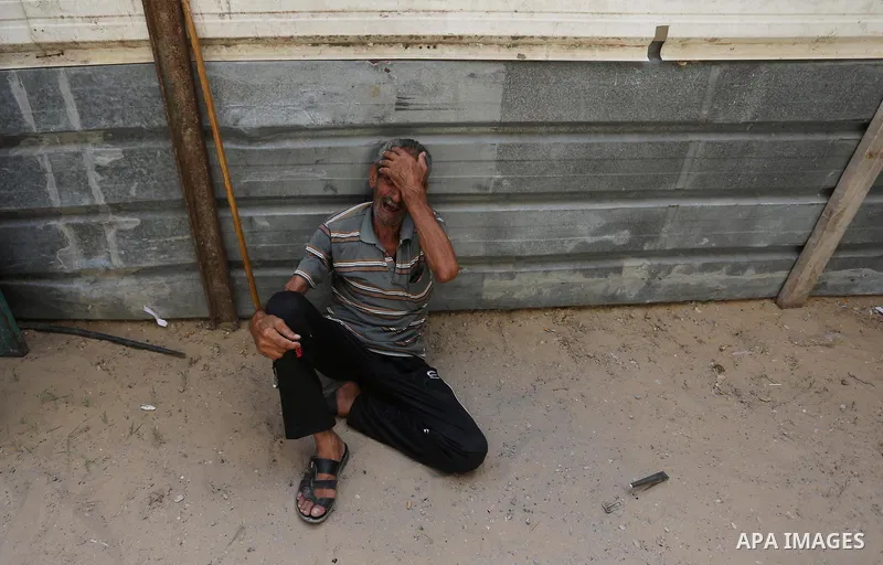 A relative of Palestinian Majdi Oqeel, who died of wounds he sustained during clashes with Israeli troops, mourns during his funeral, in Jabalia in the northern of Gaza Strip on July 24, 2018. Photo by Ashraf Amra