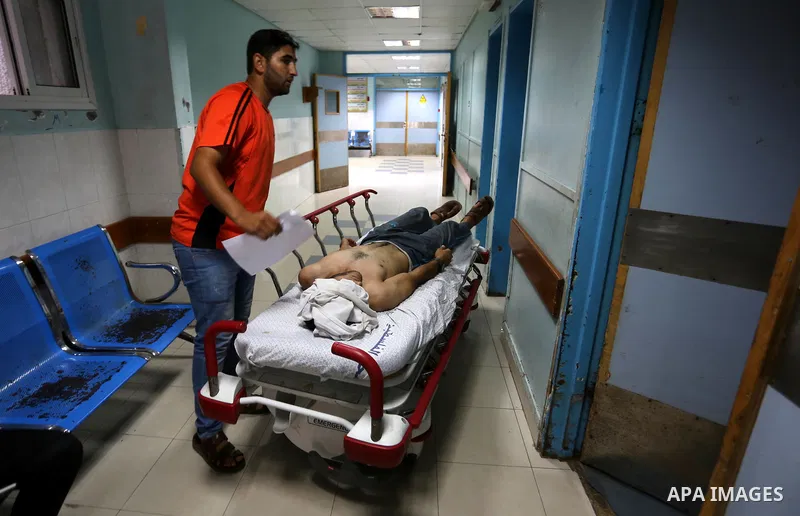 A Palestinian man who was wounded in an Israeli air strike, receives treatment at al-Shifa hospital in Gaza city on July 24, 2018. Photo by Ashraf Amra