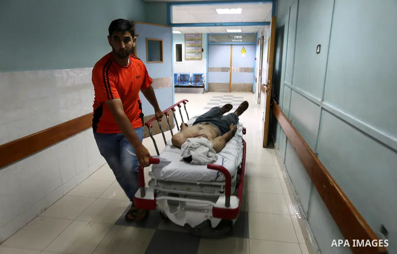 A Palestinian man who was wounded in an Israeli air strike, receives treatment at al-Shifa hospital in Gaza city on July 24, 2018. Photo by Ashraf Amra