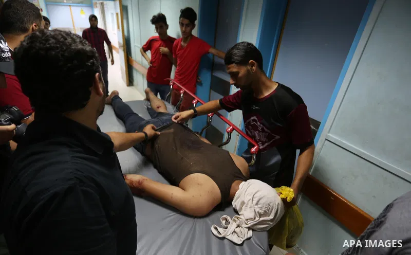 A Palestinian man who was wounded in an Israeli air strike, receives treatment at al-Shifa hospital in Gaza city on July 24, 2018. Photo by Ashraf Amra