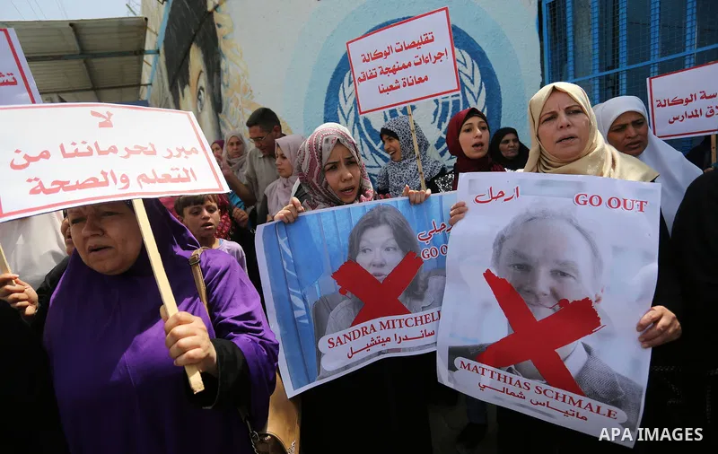 Palestinian employees of United Nations Relief and Works Agency (UNRWA) take part in a protest against jobs termination by UNRWA outside its headquarters in Gaza City, on July 25, 2018. Photo by Ashraf Amra
