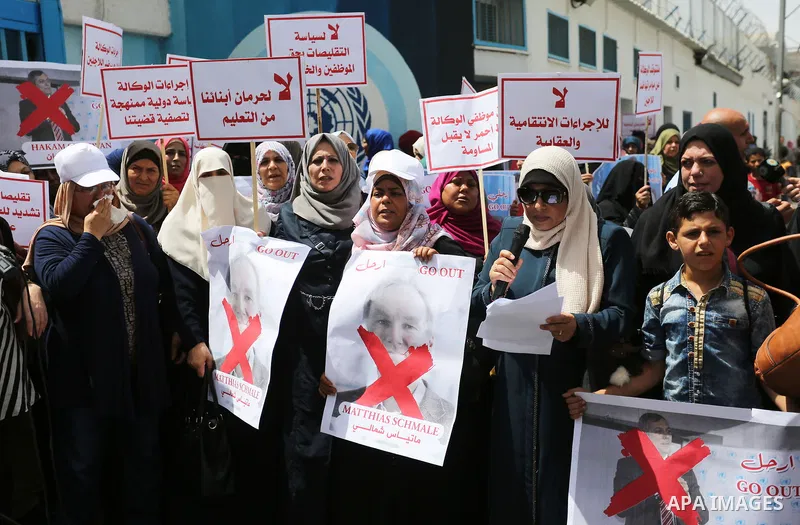 Palestinian employees of United Nations Relief and Works Agency (UNRWA) take part in a protest against jobs termination by UNRWA outside its headquarters in Gaza City, on July 25, 2018. Photo by Ashraf Amra