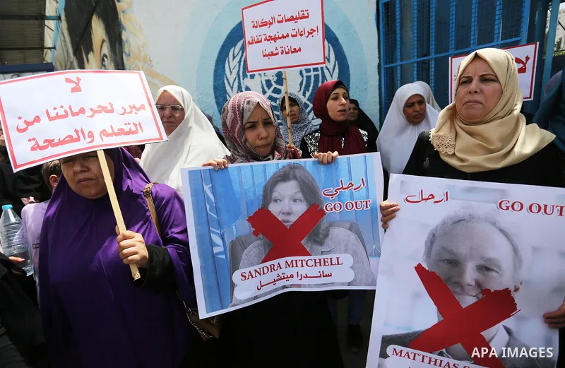 Palestinian employees of United Nations Relief and Works Agency (UNRWA) take part in a protest against jobs termination by UNRWA outside its headquarters in Gaza City, on July 25, 2018. Photo by Ashraf Amra