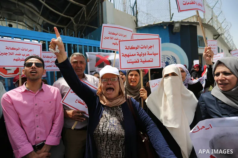 Palestinian employees of United Nations Relief and Works Agency (UNRWA) take part in a protest against jobs termination by UNRWA outside its headquarters in Gaza City, on July 25, 2018. Photo by Ashraf Amra
