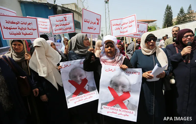 Palestinian employees of United Nations Relief and Works Agency (UNRWA) take part in a protest against jobs termination by UNRWA outside its headquarters in Gaza City, on July 25, 2018. Photo by Ashraf Amra