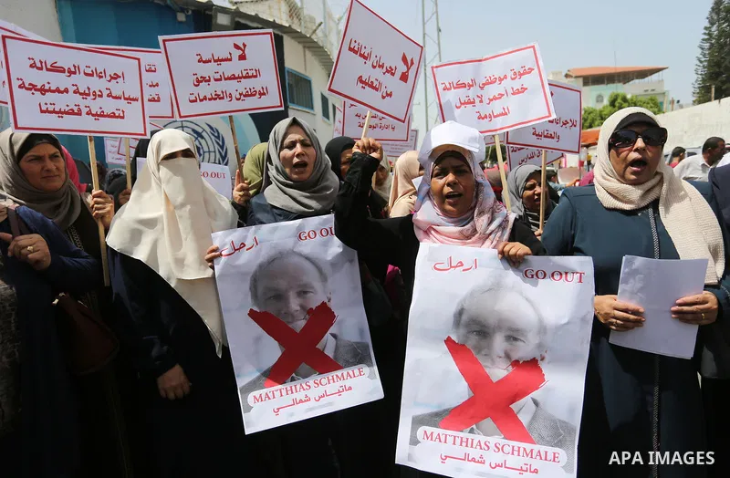 Palestinian employees of United Nations Relief and Works Agency (UNRWA) take part in a protest against jobs termination by UNRWA outside its headquarters in Gaza City, on July 25, 2018. Photo by Ashraf Amra