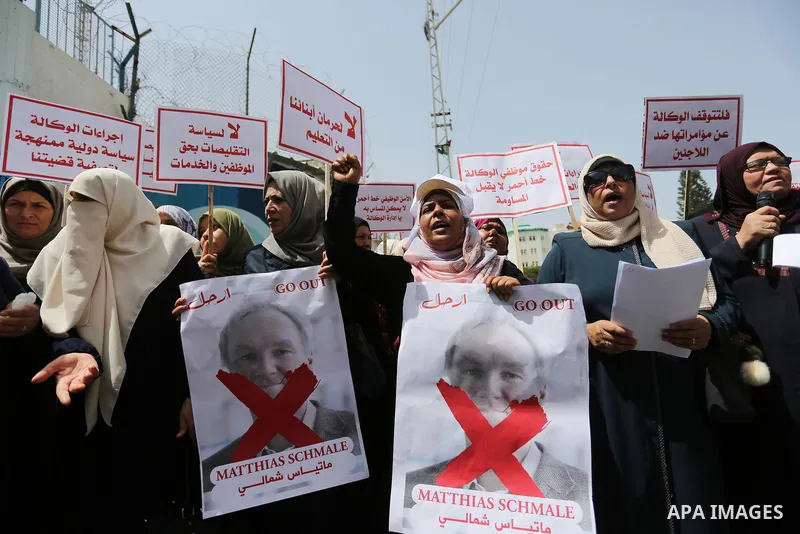 Palestinian employees of United Nations Relief and Works Agency (UNRWA) take part in a protest against jobs termination by UNRWA outside its headquarters in Gaza City, on July 25, 2018. Photo by Ashraf Amra