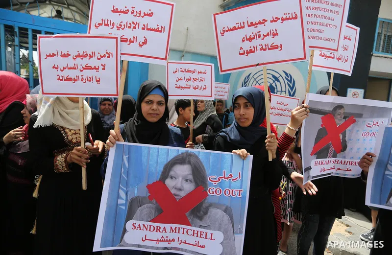 Palestinian employees of United Nations Relief and Works Agency (UNRWA) take part in a protest against jobs termination by UNRWA outside its headquarters in Gaza City, on July 25, 2018. Photo by Ashraf Amra