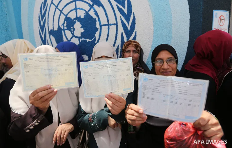 Palestinian employees of United Nations Relief and Works Agency (UNRWA) take part in a protest against jobs termination by UNRWA outside its headquarters in Gaza City, on July 25, 2018. Photo by Ashraf Amra