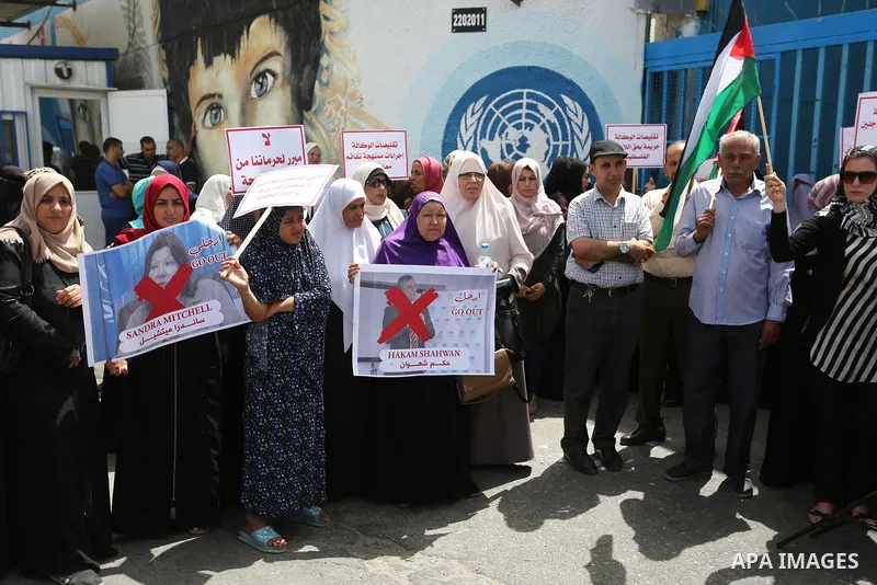 Palestinian employees of United Nations Relief and Works Agency (UNRWA) take part in a protest against jobs termination by UNRWA outside its headquarters in Gaza City, on July 25, 2018. Photo by Ashraf Amra