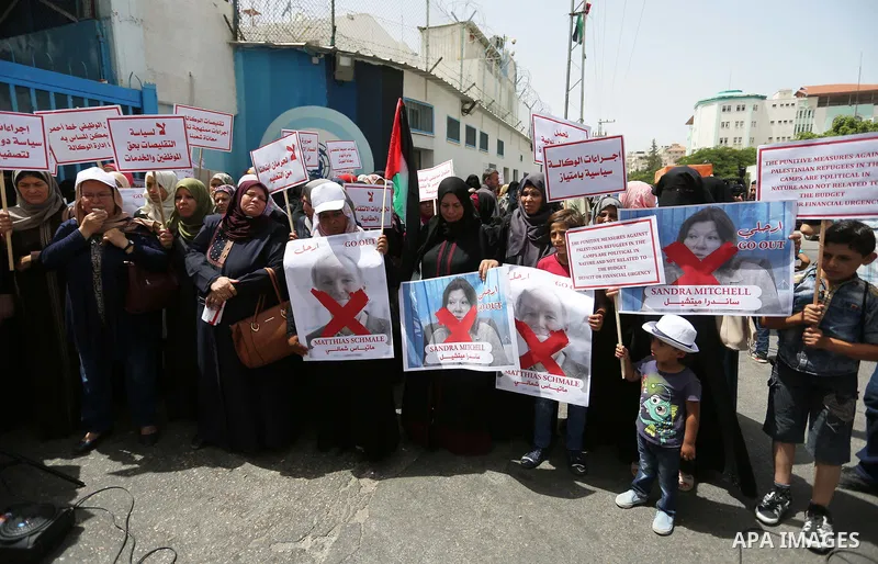 Palestinian employees of United Nations Relief and Works Agency (UNRWA) take part in a protest against jobs termination by UNRWA outside its headquarters in Gaza City, on July 25, 2018. Photo by Ashraf Amra