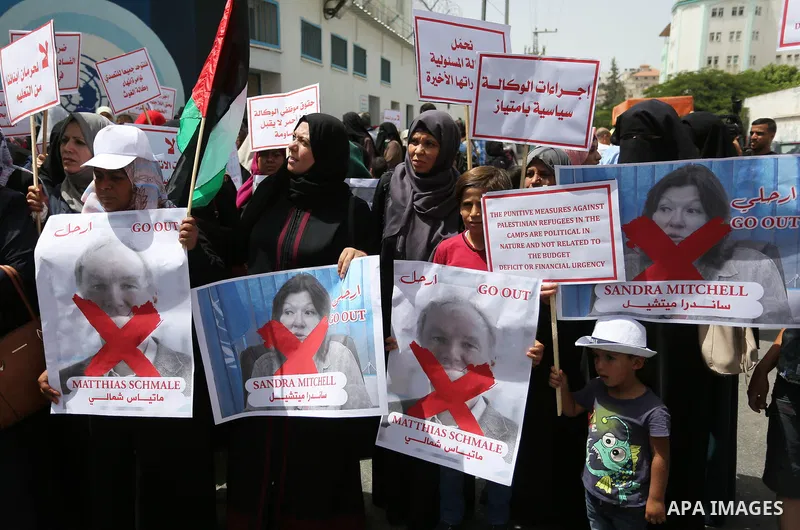 Palestinian employees of United Nations Relief and Works Agency (UNRWA) take part in a protest against jobs termination by UNRWA outside its headquarters in Gaza City, on July 25, 2018. Photo by Ashraf Amra