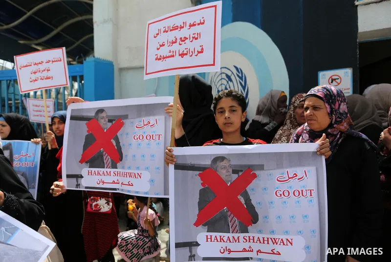 Palestinian employees of United Nations Relief and Works Agency (UNRWA) take part in a protest against jobs termination by UNRWA outside its headquarters in Gaza City, on July 25, 2018. Photo by Ashraf Amra