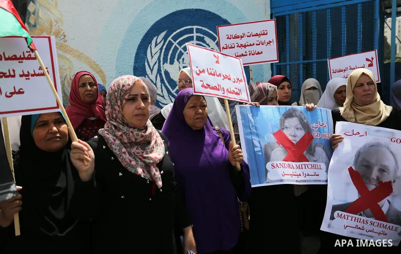 Palestinian employees of United Nations Relief and Works Agency (UNRWA) take part in a protest against jobs termination by UNRWA outside its headquarters in Gaza City, on July 25, 2018. Photo by Ashraf Amra