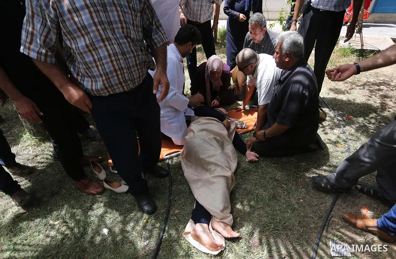 An employee of United Nations Relief and Works Agency (UNRWA) faints during a protest against jobs termination by UNRWA inside its headquarters in Gaza City, on July 25, 2018. Photo by Ashraf Amra