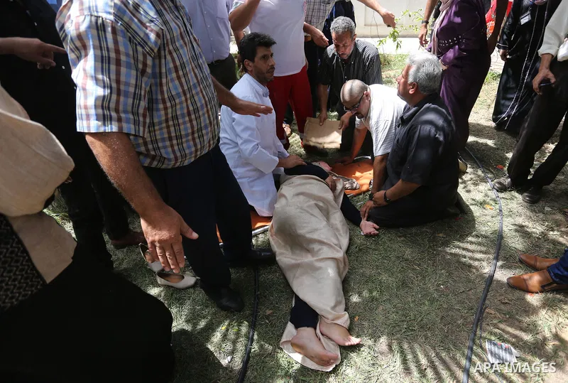 An employee of United Nations Relief and Works Agency (UNRWA) faints during a protest against jobs termination by UNRWA inside its headquarters in Gaza City, on July 25, 2018. Photo by Ashraf Amra