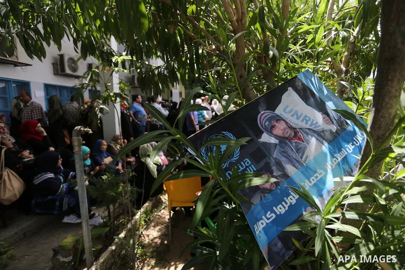 Palestinian employees of United Nations Relief and Works Agency (UNRWA) take part in a protest against jobs termination by UNRWA outside its headquarters in Gaza City, on July 25, 2018. Photo by Ashraf Amra